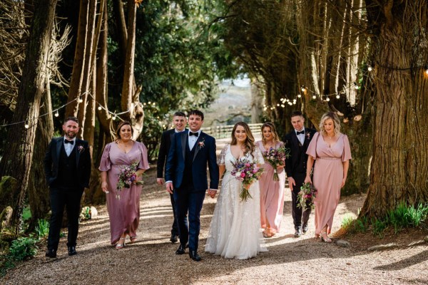 Bride bridesmaid groom groomsmen outside forest