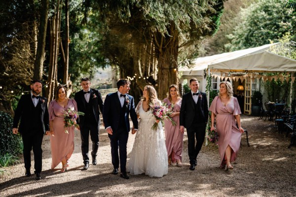 Bride bridesmaid groom groomsmen outside forest