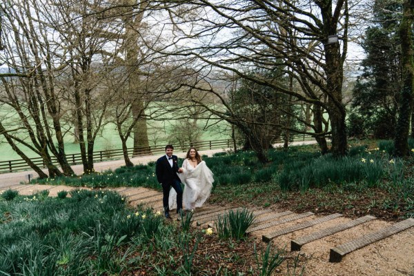 Bride and groom walking up steps in