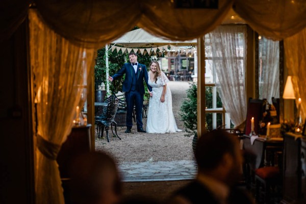 Bride and groom enter tent