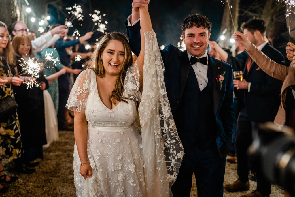 Bride and groom hands in the air