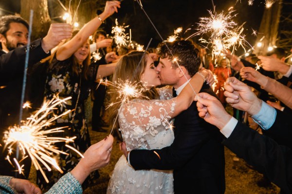 Bride and groom dancing sparklers guests