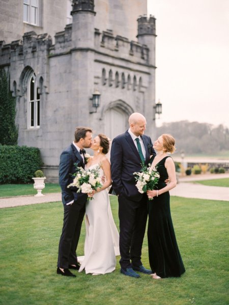 Bride and mum mother dark green dress bouquet of flowers groom kissing father kiss