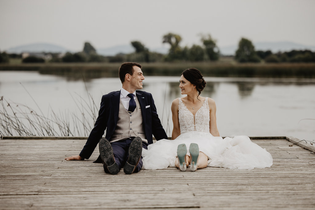 Waterfall fountain in background behind bride and groom