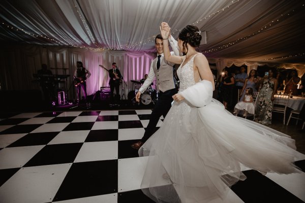 Bride and groom dancing on dancefloor