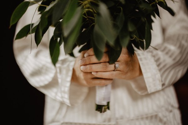 Bride ring detail holding bouquet