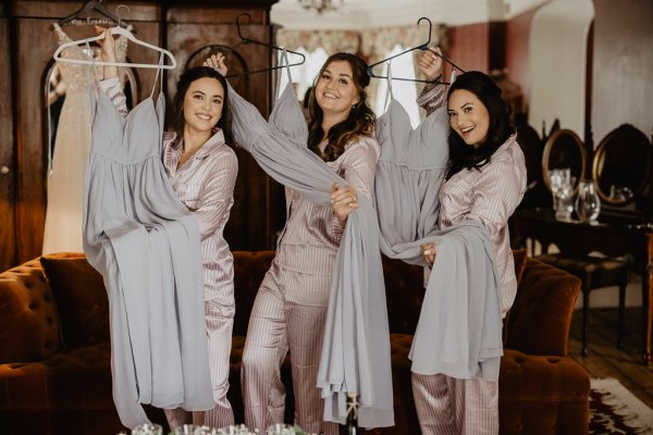 Bridesmaids holding bridesmaids gown/dress