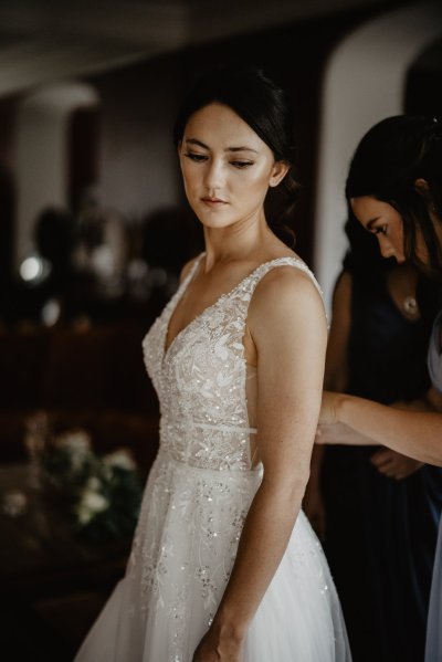 Bride is ready looks down in lace dress