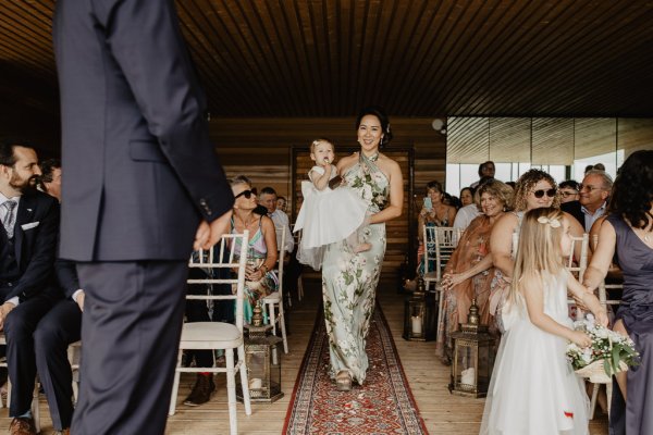 Bridesmaid and baby walk down aisle