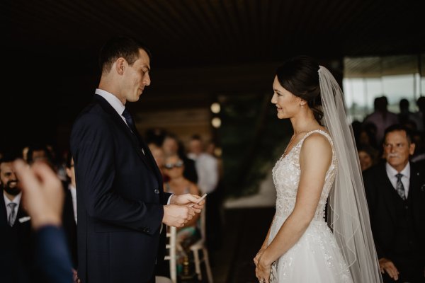 Bride and groom reading vows