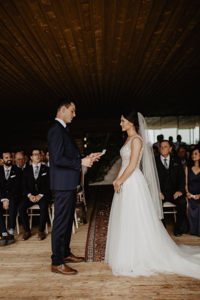 Bride and groom reading vows