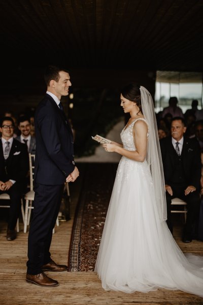 Bride and groom reading vows