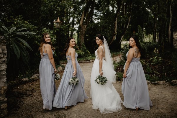 Bride and bridesmaids look behind them