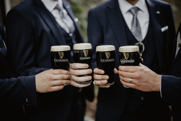 Groom and groomsmen drinking Guinness ale alcohol