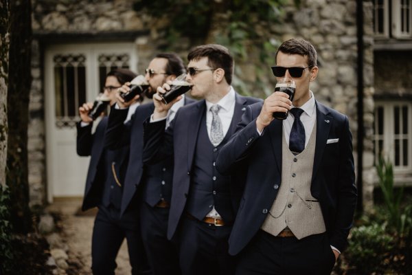 Groom and groomsmen drinking Guinness ale alcohol