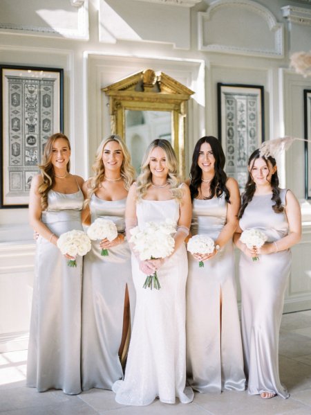 Bride with bridesmaids satin dresses maid of honour flowers bouquet