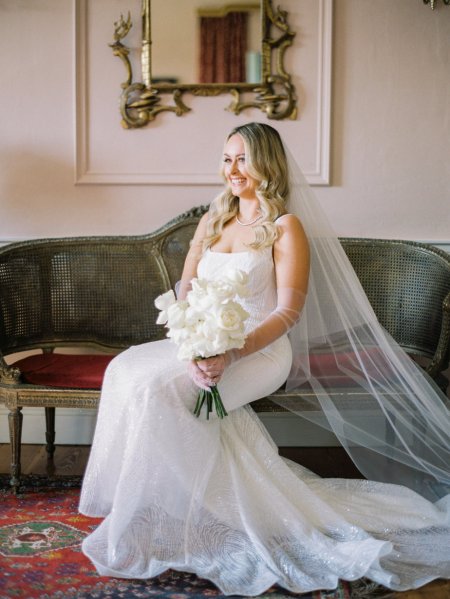 Bridal sitting on her own holding white roses flowers