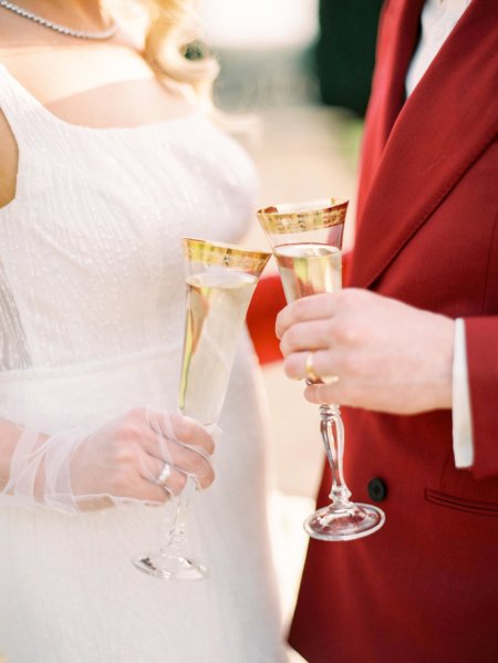 Bride and groom cheers champagne flute glasses wine