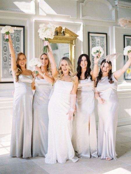 Bride with bridesmaids satin dresses maid of honour flowers bouquet