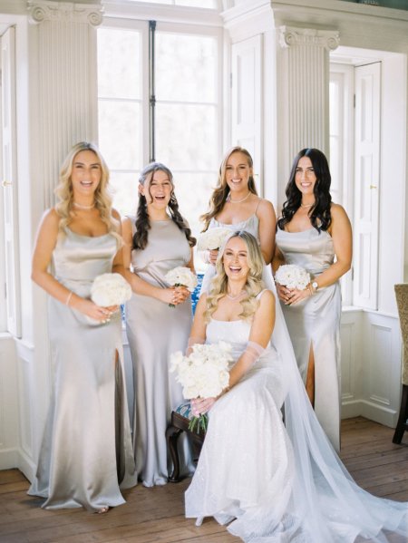 Bride with bridesmaids satin dresses maid of honour flowers bouquet