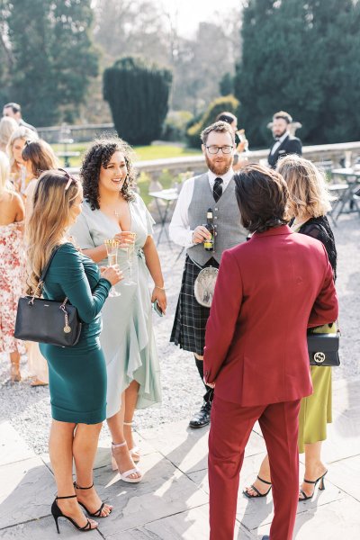 Groom and Scots man and women outside venue