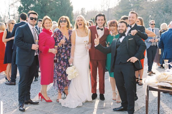 Bride groom and family members pose for a photo