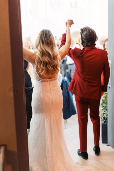 Bride and groom from behind wavy hair detail