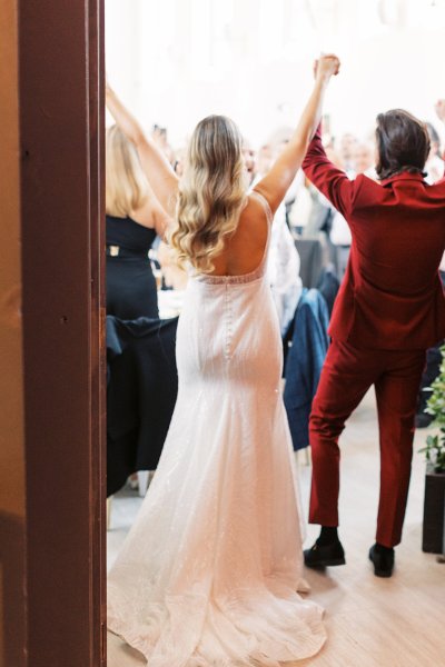 Bride and groom from behind wavy hair detail