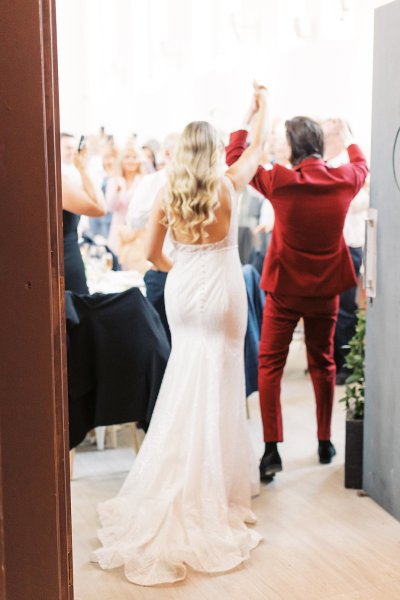 Bride and groom from behind wavy hair detail