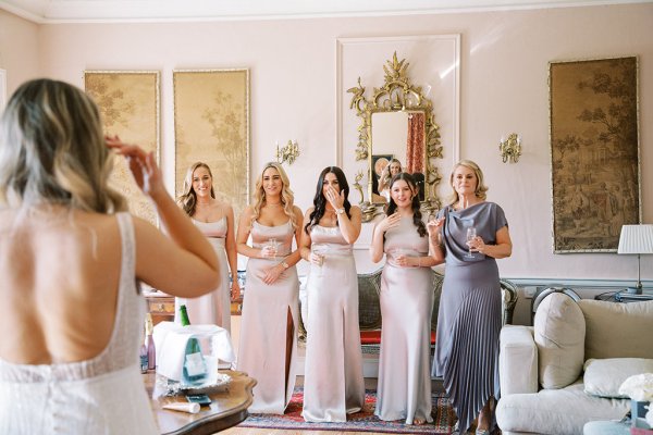 Bridesmaids see bride for the first time mother