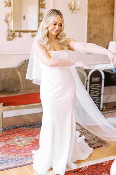 Bride holding bouquet of flowers veil