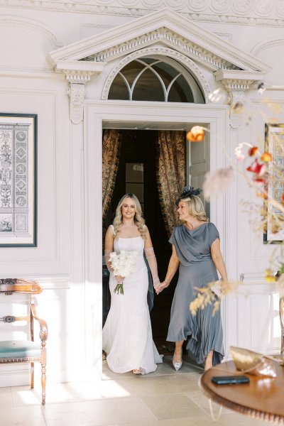 Bride and mother both holding flowers