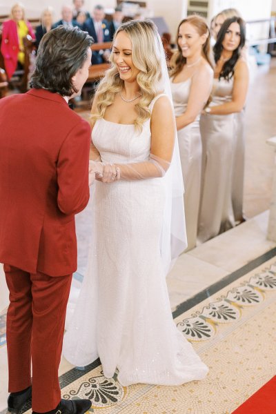 Bride and groom with guests in background