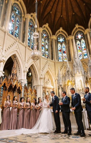 Bride and groom exit church/cathedral end of wedding ceremony guests clapping