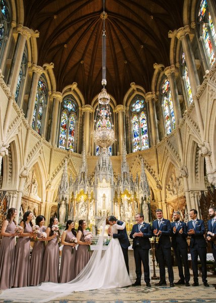 Bride and groom exit church/cathedral end of wedding ceremony guests clapping