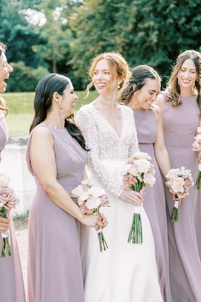 Bride with bridesmaids they are holding white flowers