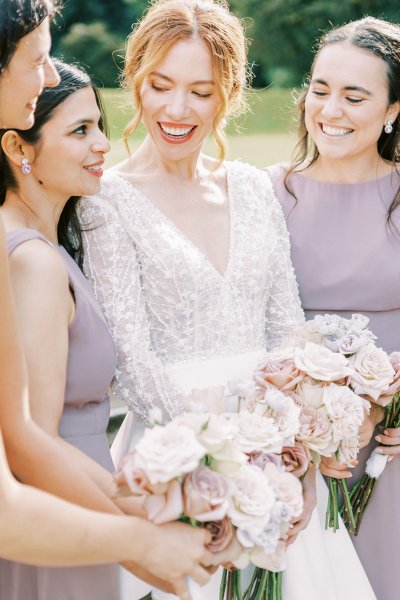 Bride with bridesmaids they are holding white flowers