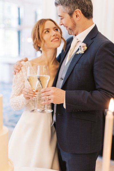 Bride and groom cheers with prosecco/champagne