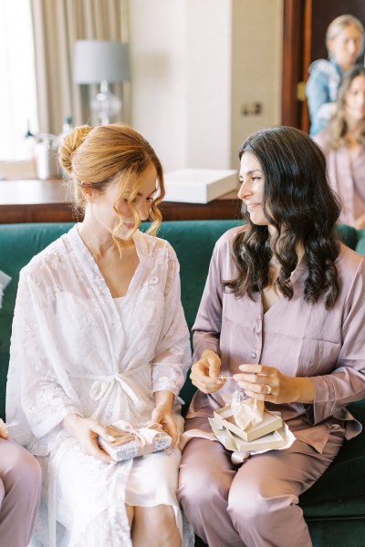 Bride and bridesmaid opening gift