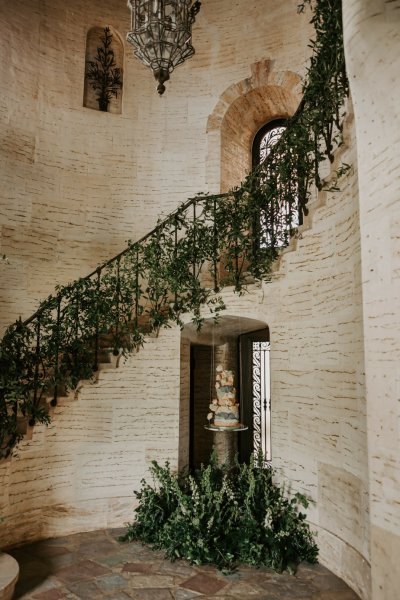 Staircase covered in flowers/ivy/ivory and wedding cake