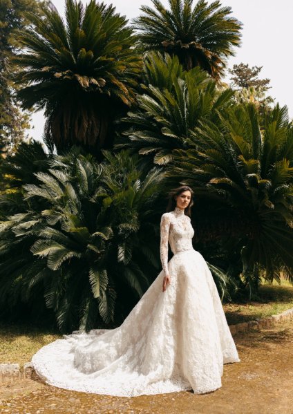 Monique Lhuillier Bridal bride outside in garden long train dress lace