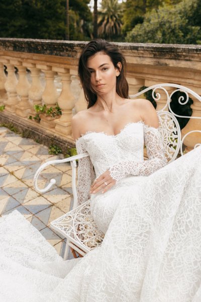 Monique Lhuillier Bridal bride outside sitting on bench off the shoulders lace gown dress