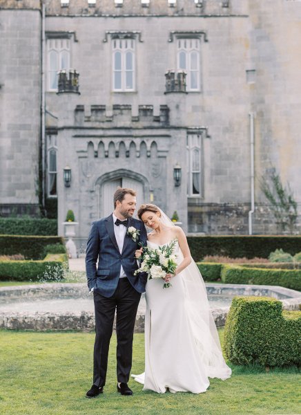 Bride and groom exterior Dromoland Castle in garden