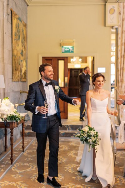 Bride and groom dining room candles lighting glass of champagne prosecco