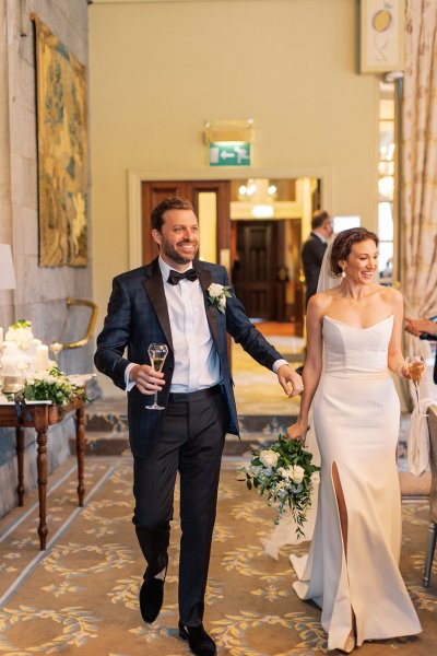 Bride and groom dining room candles lighting glass of champagne prosecco