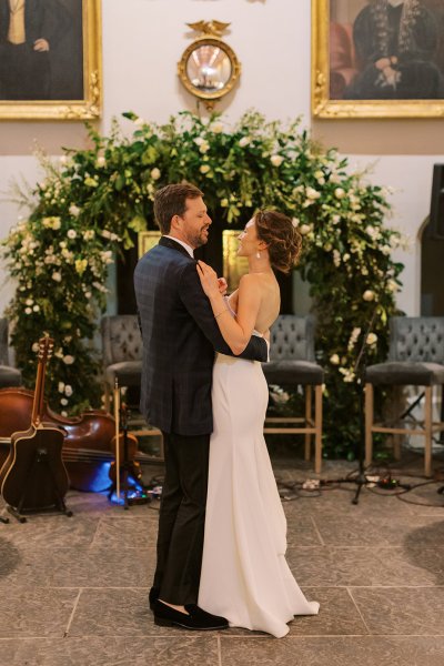 Bride and groom in front of flowers