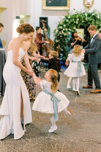 Bride dancing with little child