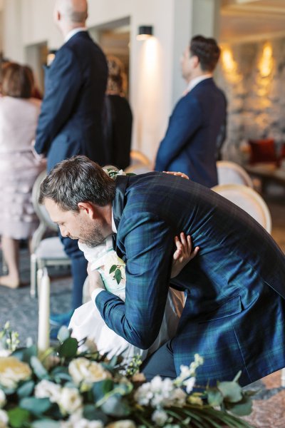 Groom hugging guest