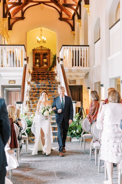 Father walking daughter bride down the aisle