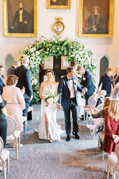 Bride and groom right after wedding ceremony guests clap and cheer